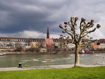 River by buildings against sky in city