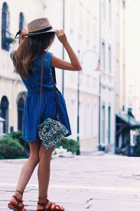 Rear view of young woman walking outdoors