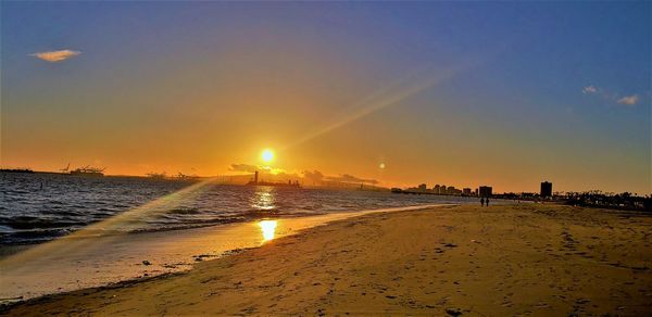 Scenic view of beach against sky during sunset