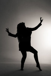 Low angle view of silhouette woman standing on stage