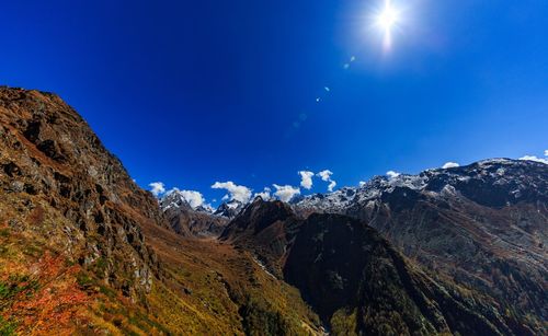 Low angle view of mountain against blue sky