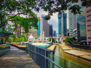 View of swimming pool by buildings in city