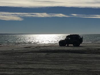 Silhouette of boat on beach