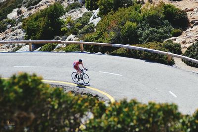 Male triathlete cyclist cycling on road