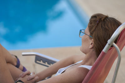 Low angle view of woman sitting at beach