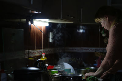Man standing in kitchen at home