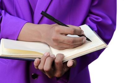 Close-up of hand holding book