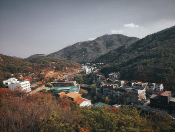 High angle view of townscape and mountains against sky