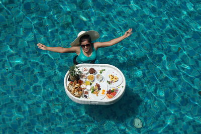 High angle view of woman swimming in pool