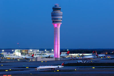 Illuminated tower against blue sky at night