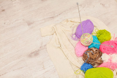 High angle view of colorful wool on wooden table