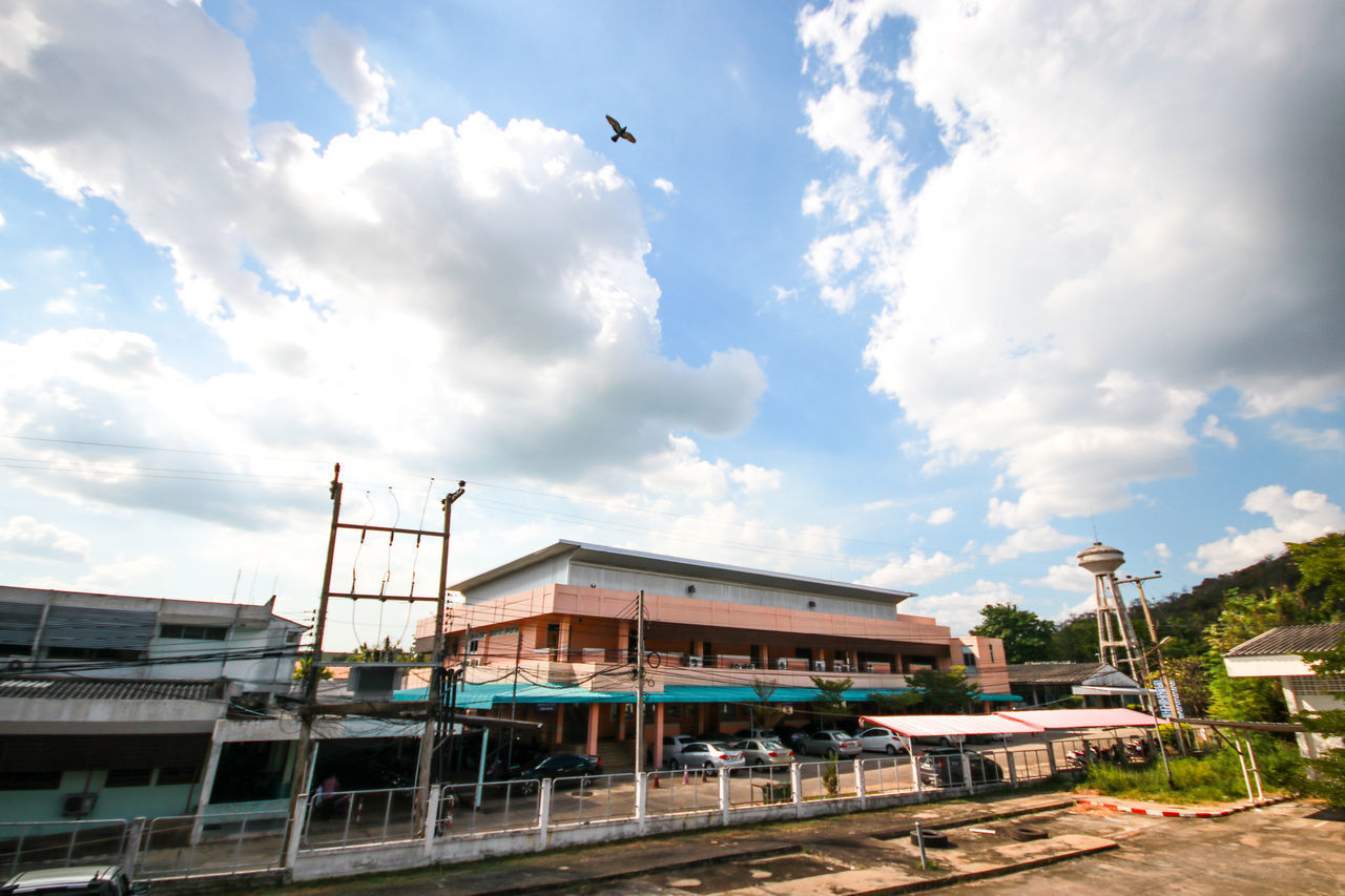 LOW ANGLE VIEW OF BUILDINGS BY STREET AGAINST SKY