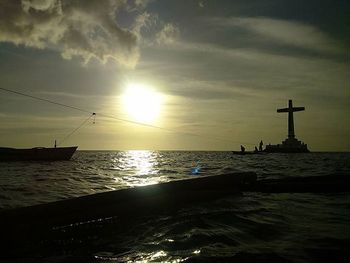 Boat sailing in sea at sunset