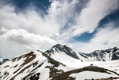 Scenic view of snow covered mountains against sky