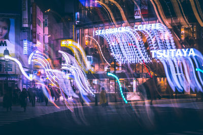 Panoramic view of illuminated street at night