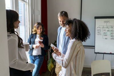 Male and female colleagues discussing in office