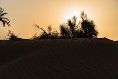 Scenic view of desert against sky during sunset