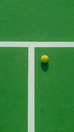 Directly above shot of yellow ball on court