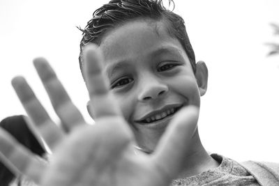 Low angle portrait of smiling boy gesturing