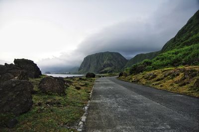 Road amidst mountains against sky