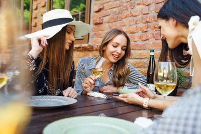 Women sitting on table at restaurant