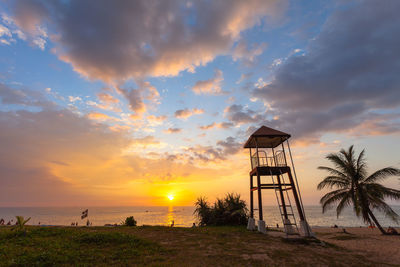 View of lifeguard hut at sea against sky during sunset