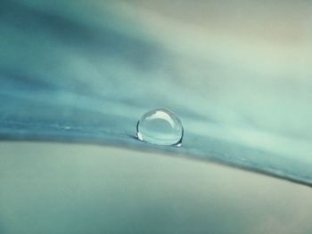Close-up of bubbles in water against sky