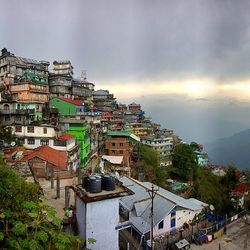 View of cityscape against cloudy sky