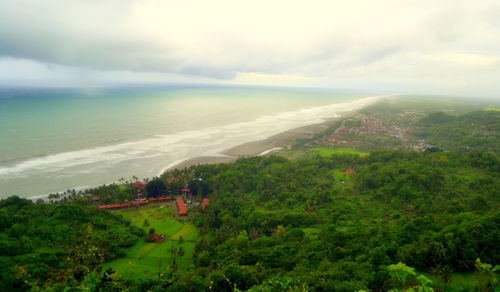 High angle view of trees and sea against sky