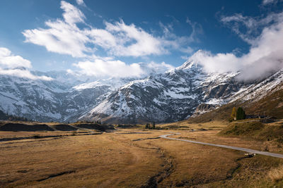 Snow capped mountains above fall colored highland in gastein, salzburg, austria