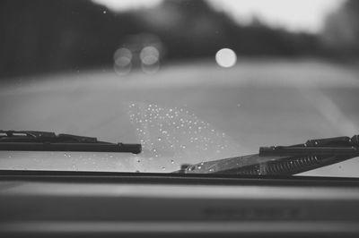 Close-up of wet car on river against sky