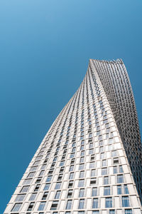 Low angle view of modern building against clear blue sky