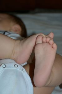 Close-up of baby boy sleeping on bed at home