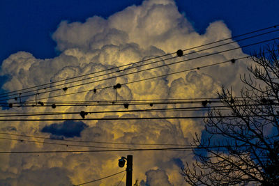 Low angle view of electricity pylon against sky