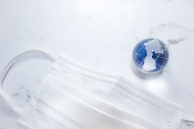 High angle view of glass of white paper on table
