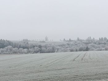 Scenic view of agricultural field against sky during winter