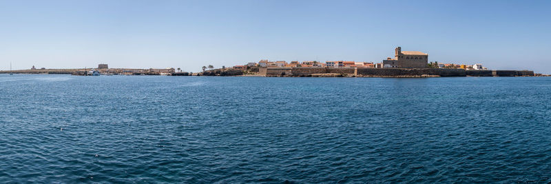 Sea against buildings in city