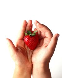 Child handing strawberry fruit 2 hands