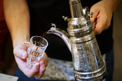 Close-up of hand holding glass of drink