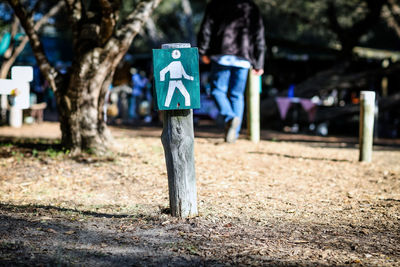 Rear view of woman walking on footpath