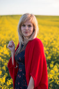 Portrait of beautiful young woman in field