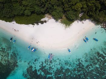 Aerial  view of people boats moored at beach