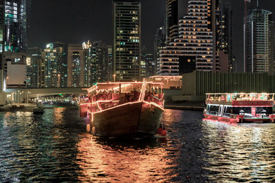 Illuminated buildings in river at night