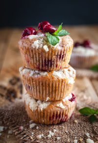 Close-up of cherry muffins with crumbly topping on wooden background