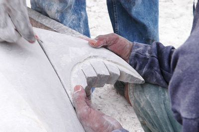 Cropped hand of man holding sculpture