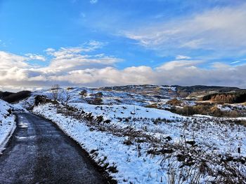 Scenic view of snow covered landscape against sky