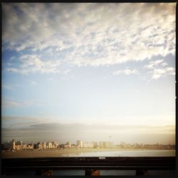 View of city against cloudy sky