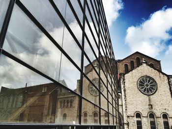 Low angle view of building against cloudy sky