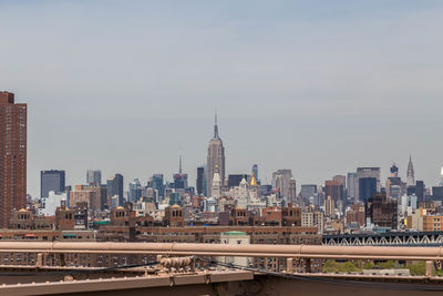 Distant view of empire state building seen from brooklyn bridge