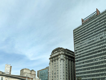 Low angle view of modern buildings in city against sky